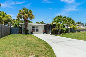 A residential house with a front yard, a driveway, and a garage.