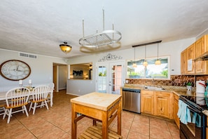 Enjoy cooking in this well-equipped kitchen with a central island, dishwasher, and stainless steel sink.
