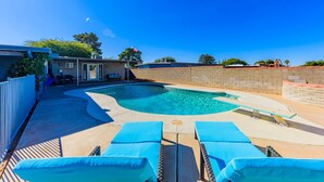 A swimming pool with lounge chairs, a brick wall, and a clear blue sky. - Casa De Azul ~ Fabulous Private Pool Paradise ~ Spacious And Comfy! (Tucson)