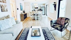 A modern living room with a sofa, a coffee table, and a patterned rug. - Quiet retreat near Coconut Grove + free parking (Miami)