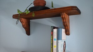 A wooden shelf with a potted plant and books. - Wake & Bake Vegas (Las Vegas)