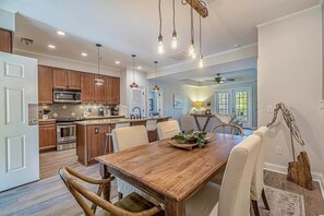 Enjoy a comfortable living area with a modern kitchen, dining table, and comfortable seating.