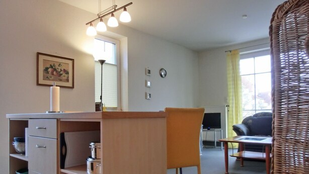 A compact living space with a kitchenette, a dining area, and a seating area with a television. - Apartment i25 - 56 m² large 3-room apartment 3 pers. on the 1st floor in the house Lee (Graal-Müritz)
