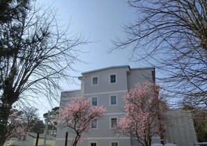 A multi-story building with a flat roof and a symmetrical facade.