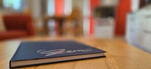 A book on a wooden table with a blurred background.