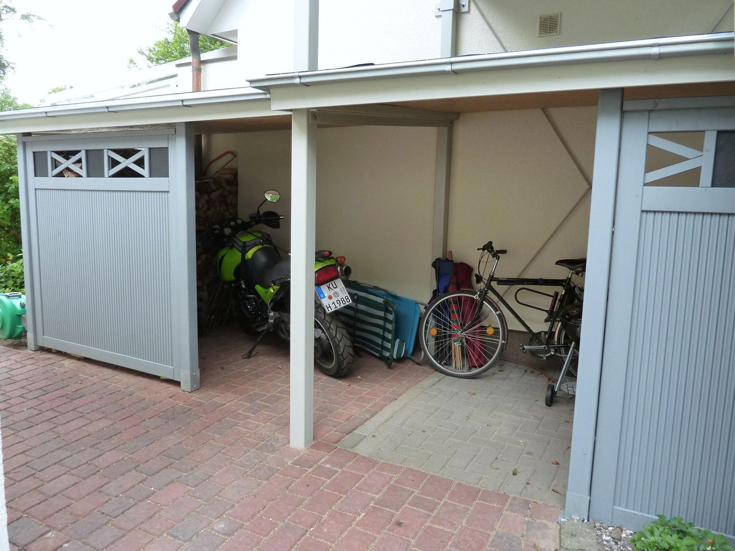 A garage with a motorcycle and a bicycle inside.