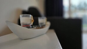 A glass of red wine on a white tray on a table. - Apartment KWV 1 ground floor - 2-room apartment for 3 pers. on the ground floor and garden (approx. 30 m²) (Graal-Müritz)