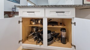A kitchen with white cabinets, a granite countertop, and various kitchen utensils and appliances. - Cozy newly remodeled home close to major amenities  in Connecticut a (Middletown)