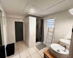Bathtub, hair dryer, towels, toilet paper