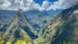 A mountainous landscape with a prominent peak and valley.