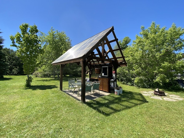 Enjoy al fresco dining in this charming outdoor space, complete with a barbecue area and scenic views.