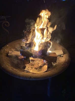 Enjoy a warm gathering around the fire pit, surrounded by the peaceful outdoors.