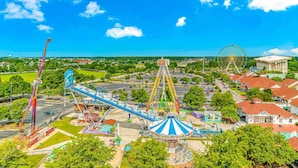 A large amusement park with various rides and a Ferris wheel. - Spacious 2 bedroom just a 2 min walk to the beach! Pet Friendly. Pool (Myrtle Beach)