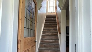 A wooden staircase leading to a room with a view of the outdoors. - Acacia House  - Holiday Cottage Wolsingham (Wolsingham)