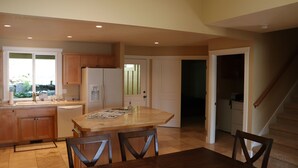 A spacious kitchen with a large island, wooden cabinets, and a dishwasher. - Easy freeway access, 1.5 miles to Hayward Field (Eugene)