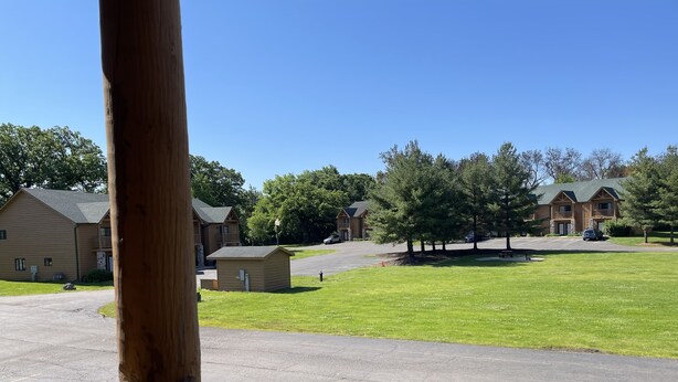 A view of a building complex with multiple structures, a grassy area, and a parking lot. - Newer Rustic WiFi Villa by Starved Rock sleeps 7. A guest favorite!! (Utica)