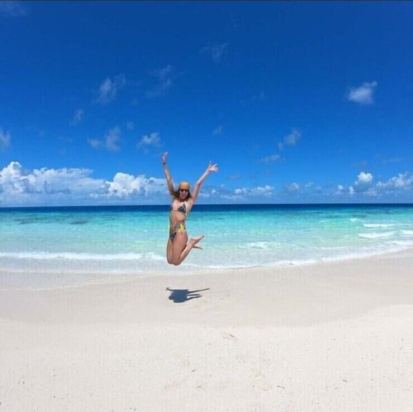 On the beach, white sand, free beach shuttle, beach umbrellas