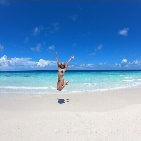 On the beach, white sand, free beach shuttle, beach umbrellas