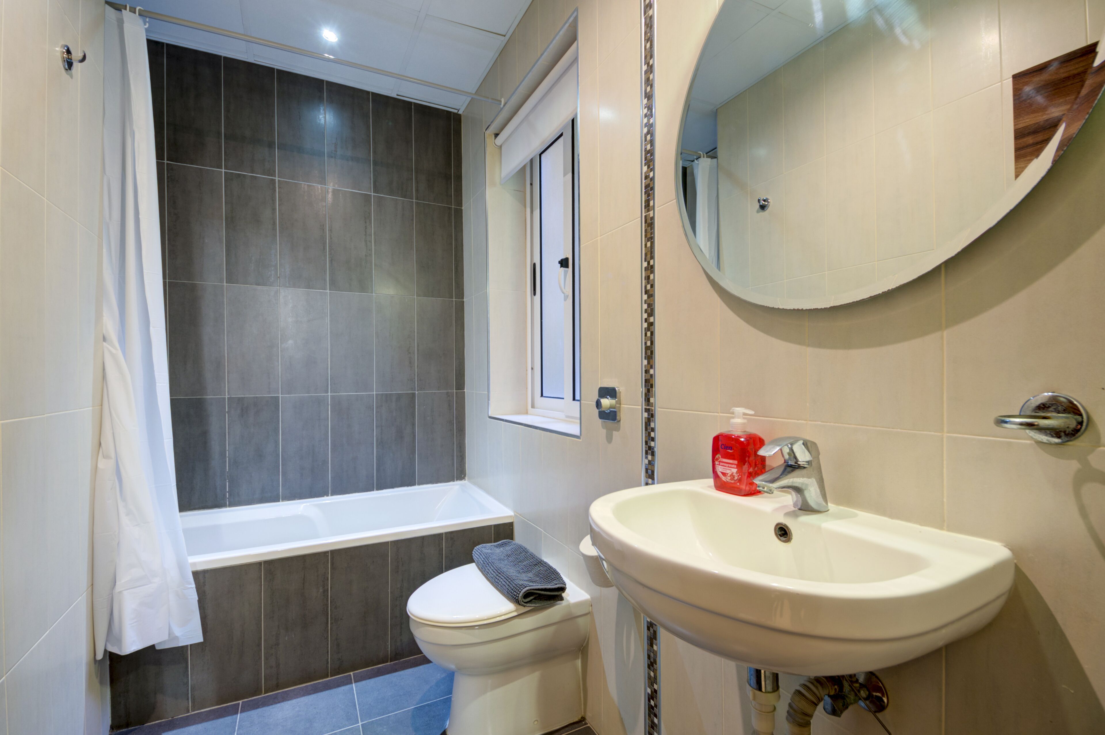 A bathroom with a bathtub, toilet, and sink.