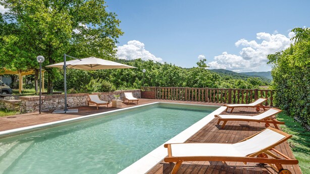 A pool area with wooden loungers, a pergola, and a view of the mountains. - Awesome home in Rieti with WiFi (Rieti)