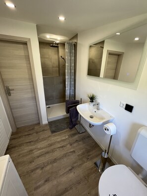 Bathtub, towels, soap, toilet paper