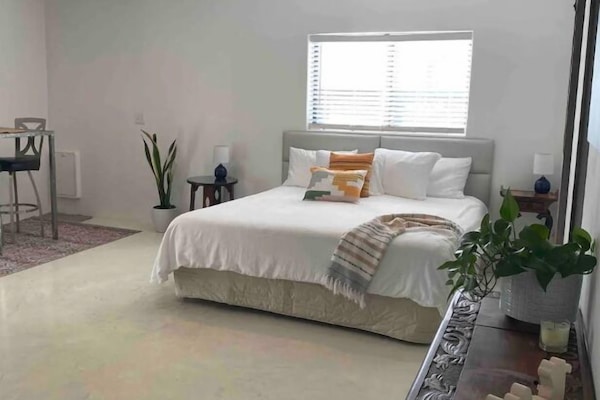 Very comfortable king Tempurpedic bed made up with nice sheets and pillows.