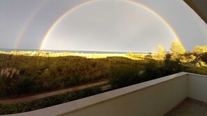 A balcony with a view of a grassy field and a rainbow. - Sea front apartment, fine sandy beach, trabocchi coast (Marina di Vasto)