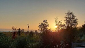 A sunset view with trees and a paved path. - Sea front apartment, fine sandy beach, trabocchi coast (Marina di Vasto)
