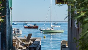 A marina with several boats docked, wooden benches, and a clear blue sky. - Charming house in Biscarrosse Plage with heated swimming pool  (Nouvelle-Aquitaine)
