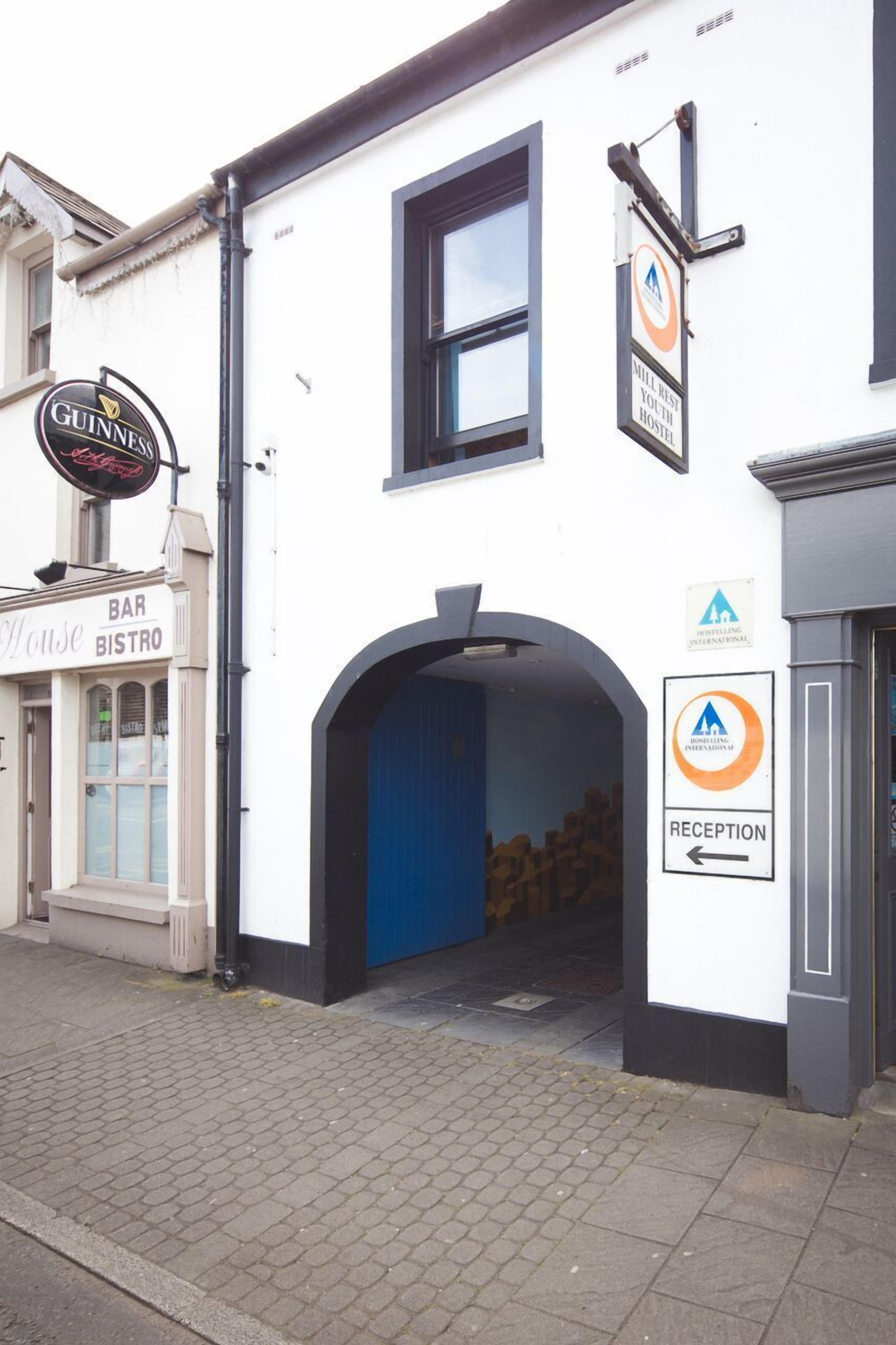 A building with a 'GUINNESS' sign, a 'BAR BISTRO' sign, and a 'RECEPTION' sign pointing to the right.