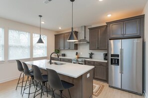 Fridge, microwave, coffee/tea maker, cookware/dishes/utensils