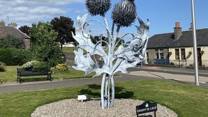 A metal sculpture of a plant with a bench and a sign in a park. - Well equipped dog friendly cottage ideal for relaxing, walking, cycling, golf (Crieff)