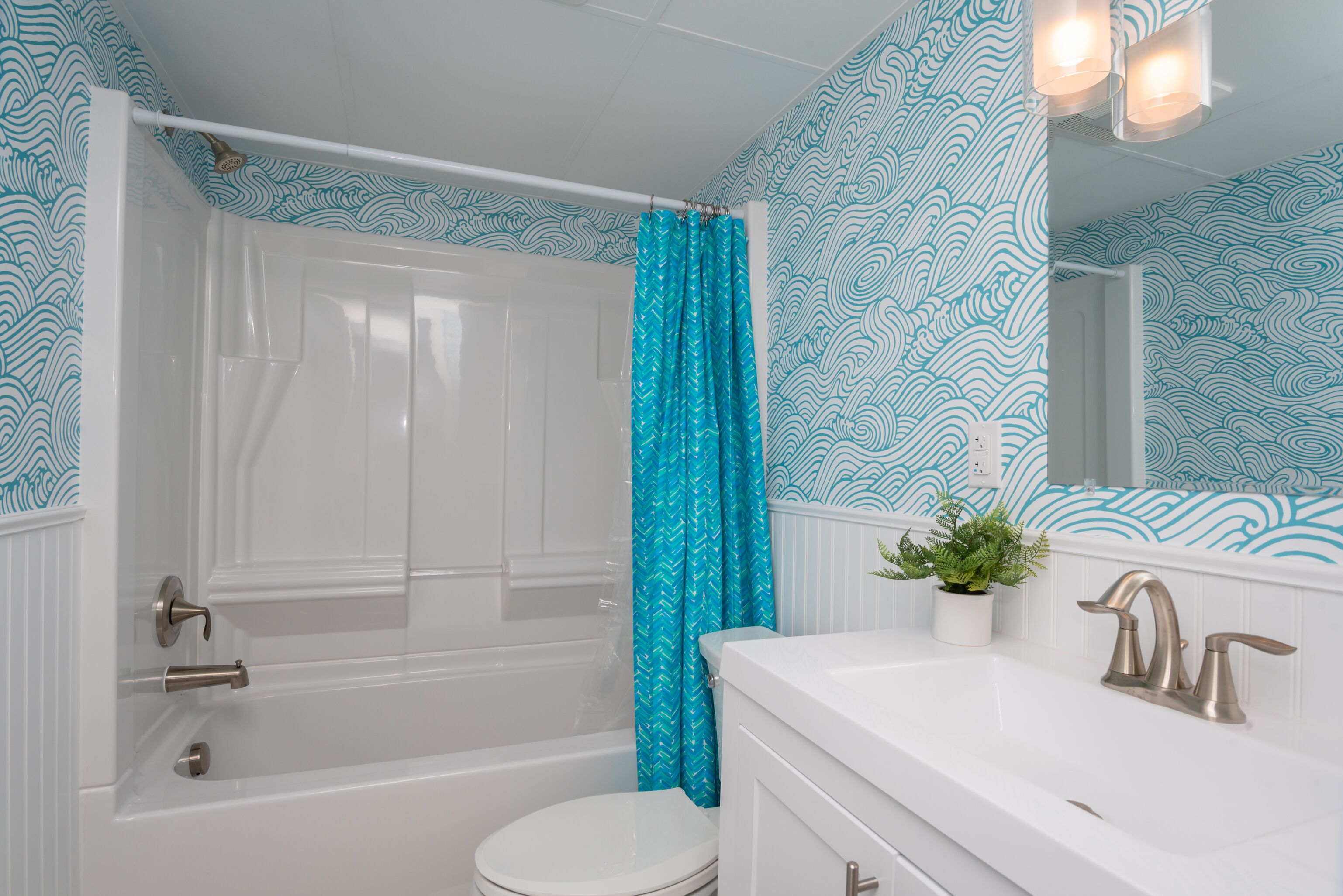A bathroom with a bathtub, toilet, and sink.