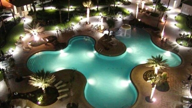 A pool area with multiple sections and lounge chairs. - On the Brink of the Gulf, 3BR with a 3 Minute Walk to the Beach (Destin)