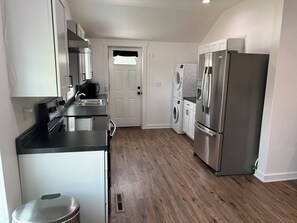 A modern kitchen with stainless steel appliances, a built-in oven, and a dishwasher.