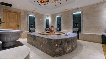 Relax in a spacious bathroom with a central island, bathtub, and large mirrors.