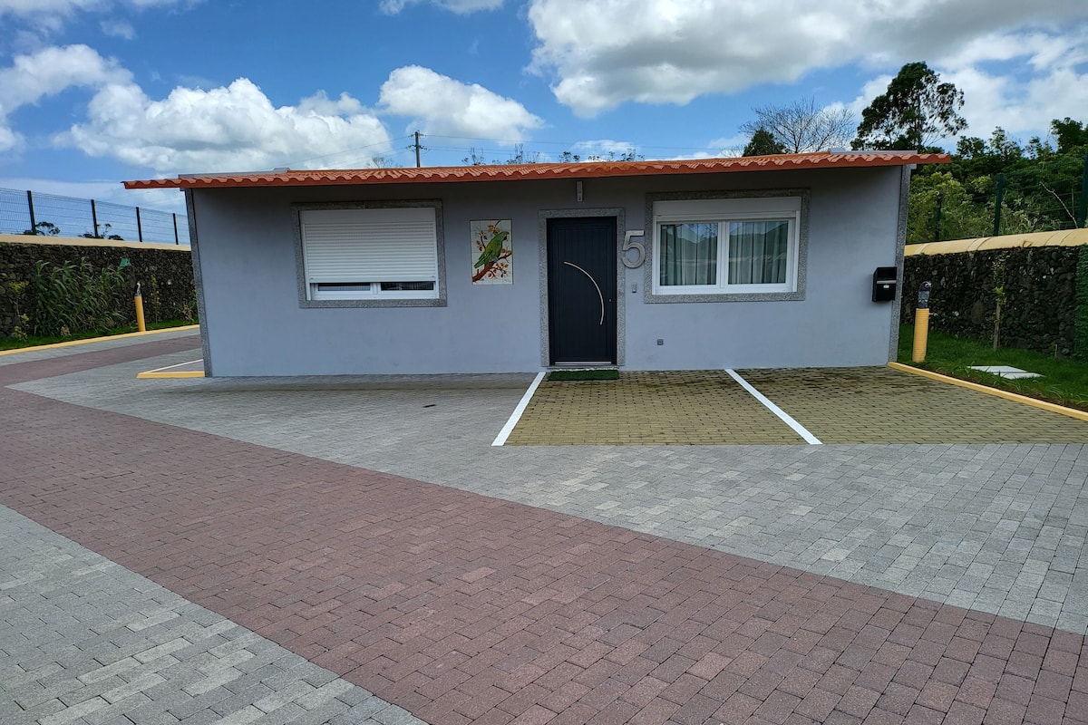 A small, single-story building with a tiled roof and a number '5' on the facade.