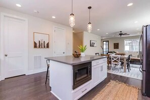 Enjoy meals in the kitchen with a central island, microwave and oven, and dining area nearby.