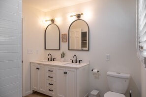 A bathroom with a white vanity, two sinks, a toilet, and two wall-mounted mirrors. - Luxe Waterfront Retreat w/ Infrared Sauna & Red Light. Near New Paltz (wallkill)