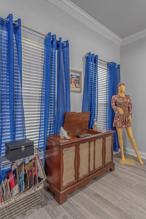 Classic design room with a wooden chest of drawers, framed picture, and a mannequin.