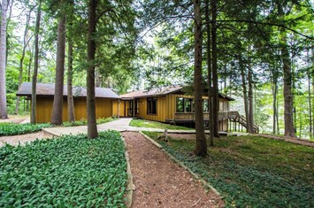 Approach to home, garage on left, covered walk way from garage to home. 