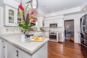 Enjoy cooking in this well-equipped kitchen with a large island, sink, and ample storage.