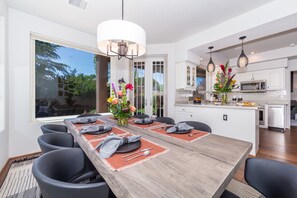 Enjoy meals in this dining area with a long table for six and a view of the outdoors.