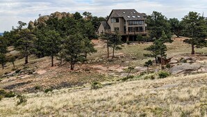 A two-story house with a large deck, surrounded by trees and rocky terrain. - Vedauwoo, Curt Gowdy State Park, Cheyenne, and Laramie  close! (Cheyenne)