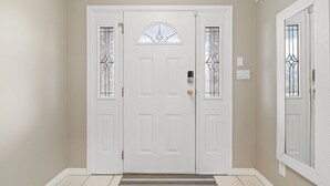 A white double door with a glass panel and a small window above it. - Beautiful Home in Langley with Huge Patio (Langley)
