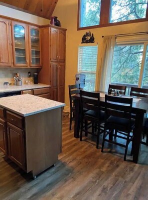 Enjoy meals in the spacious kitchen with a large island and dining tables.