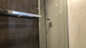A glass shower enclosure with a chrome handle and a control panel. - K I G Heights U24 with Panoramic Kings Beach Views (KINGS BEACH)