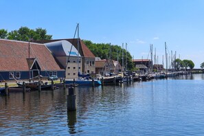 Boats docked along the marina's edge, surrounded by buildings with unique architectural styles.