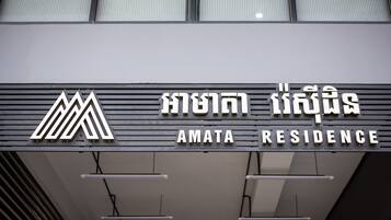 A sign for Amata Residence with a modern design and a logo.
