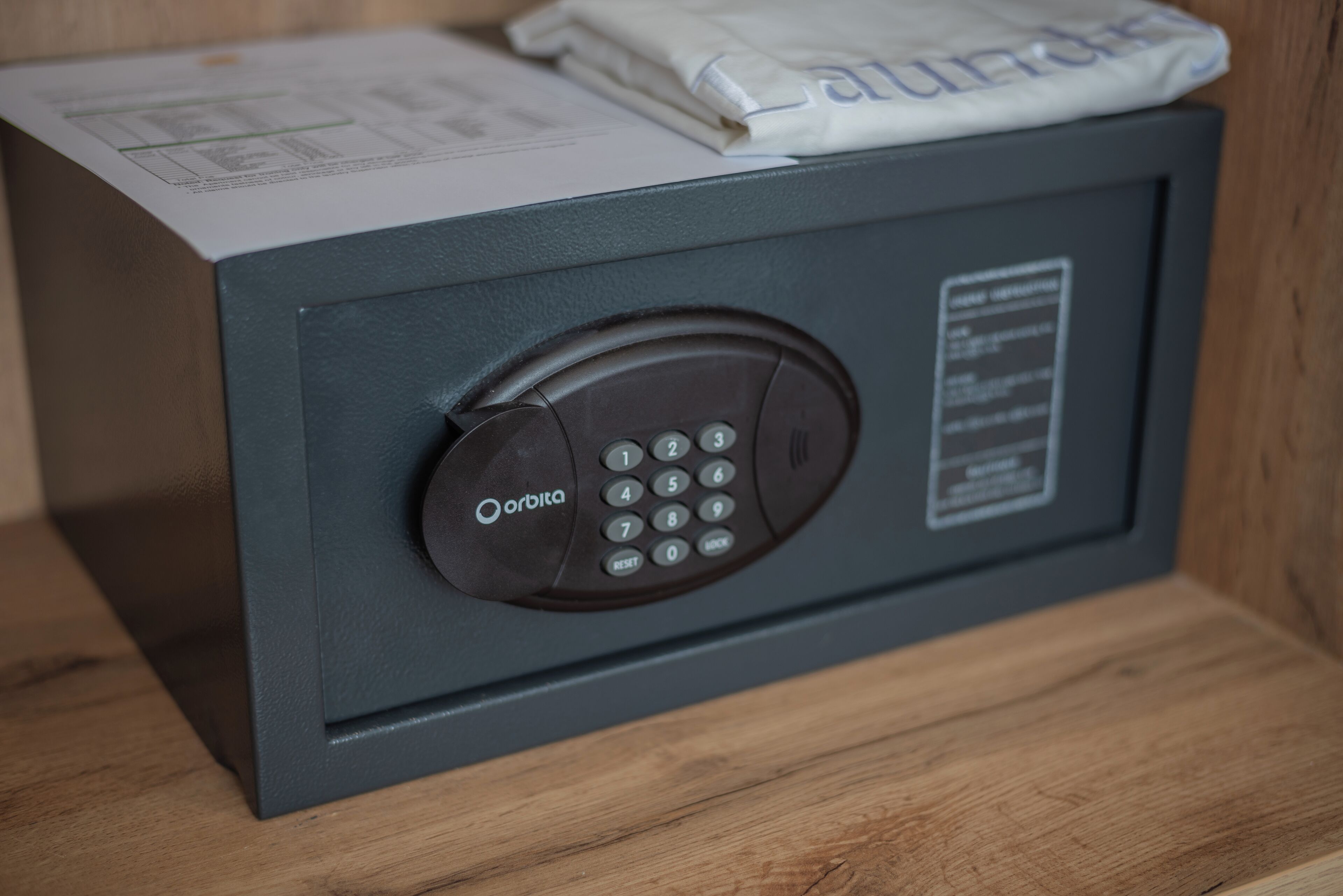 A safe with a keypad and a label that reads "Orbita."